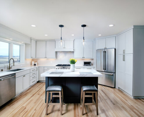 kitchen remodel with white cabinetry and gray island