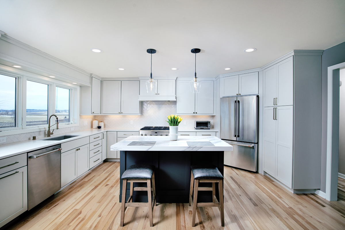 kitchen remodel with white cabinetry and gray island