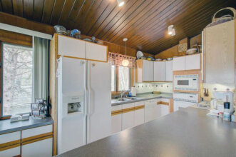 kitchen with wood ceiling and white cabinetry