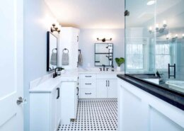 master bathroom with mosaic tile floor and white cabinetry
