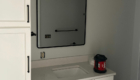guest bathroom black rimmed mirror installed